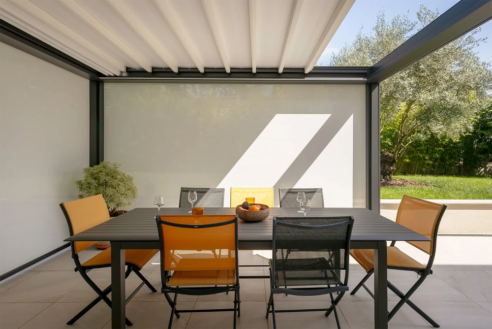 Terrasse extérieure moderne sous pergola bioclimatique à lames orientables en aluminium blanc