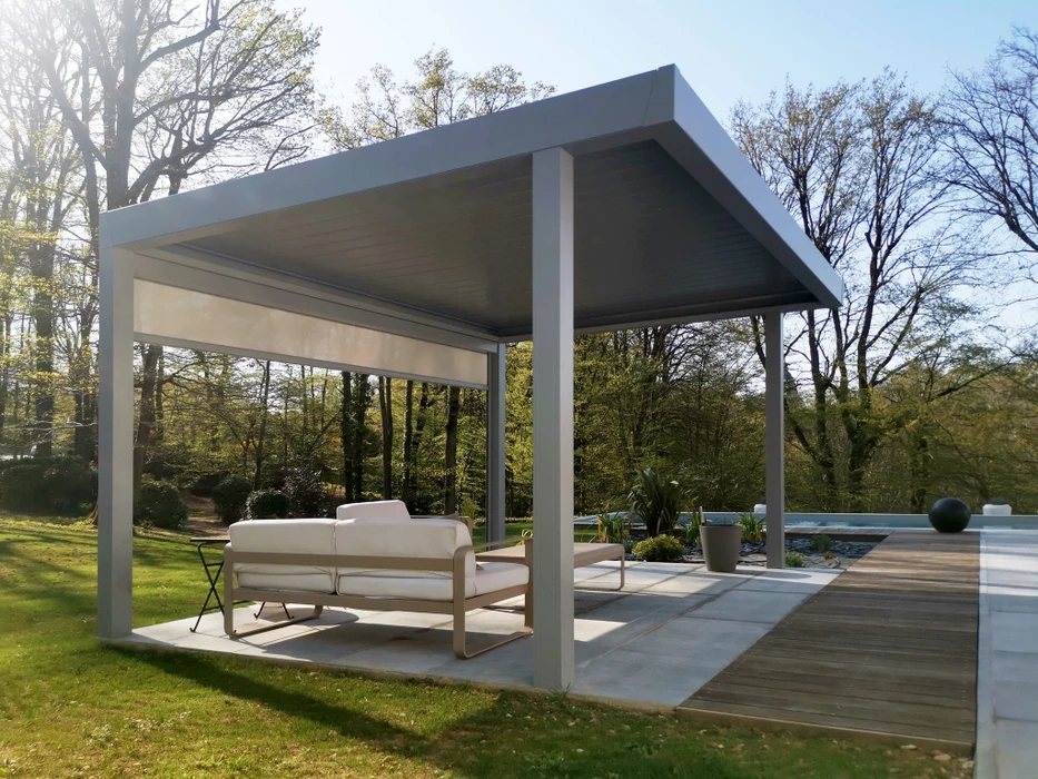 Pergola bioclimatique aluminium anthracite autonome, toiture à lames orientables, montée sur terrasse en bois composite